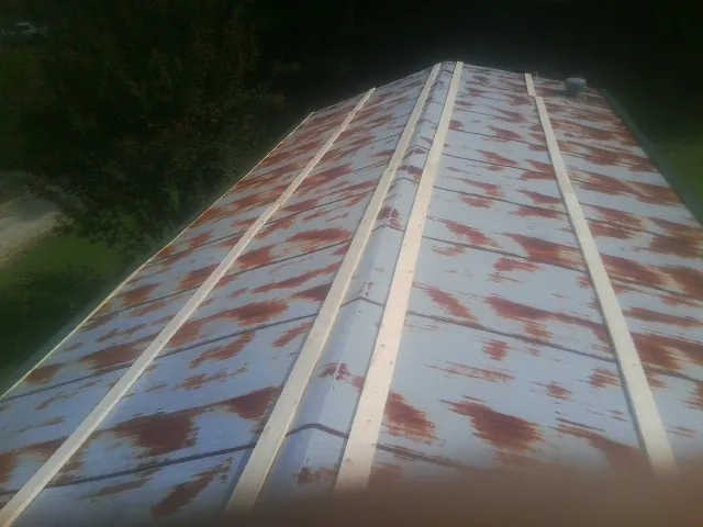 Rusted metal roof panels with new wood purlins before replacement — Storm Damage Roof Repair in Tivoli by Roofing Brothers